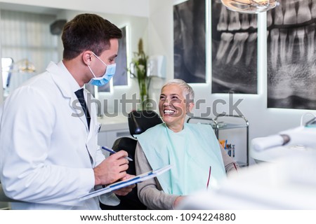 Beautiful senior woman at dentist\'s office satisfied after successful dental treatment.