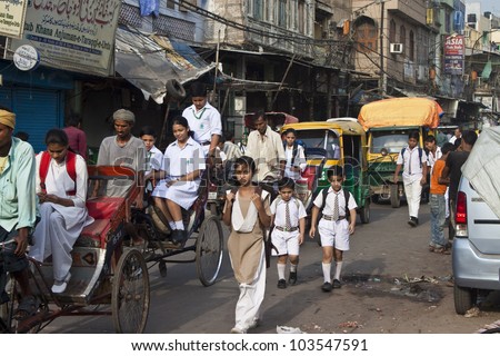 OLD DELHI, INDIA - AUGUST 3: Unidentified children on their way to a school at August 3, 2011 in Old Delhi, India.  Education is free for children for 6 to 14 years of age in India.
