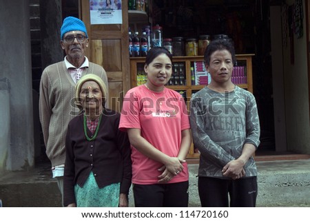 SIKKIM, INDIA - AUGUST 18: Local family standing in front of their small shop in a village on August 18, 2011 in Sikkim, India. Sikkim is an Indian state located in the Himalayan mountains.