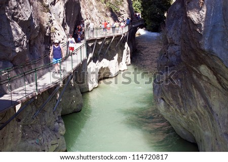 SAKLIKENT, TURKEY - JULY 27: Tourists walk in a canyon at July 27, 2011 in Saklikent, Turkey. Saklikent Canyon is located in southern Turkey. It is 300 meters deep and 18 km long.