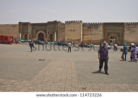MEKNES, MOROCCO - JUL 28: people in front of a famous Bab el-Mansour gate on Jul 28, 2010 in Meknes, Morocco. Meknes is a historic city listed in UNESCO and it has long tradition in handicrafts
