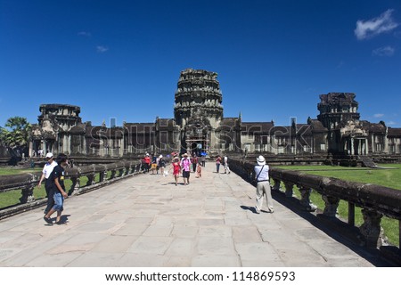 ANGKOR WAT - JULY 15 : Unidentified tourists at Cambodia\'s most famous tourist attraction, the temple Angkor Wat July 15, 2012 in Siem Reap, Cambodia.