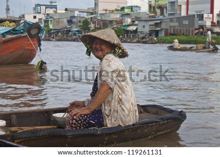CAN THO, VIETNAM- JULY 24:Unidentified woman at a boat at Cai Rang Floating Market in Can Tho, Vietnam on July 24, 2012. Cai Rang Market is the biggest floating market in the Mekong Delta