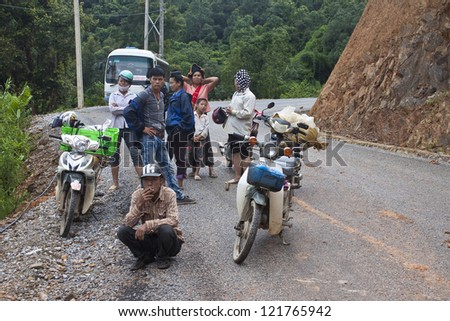 NORTHERN LAOS - AUGUST 14: People wait for clearing a road after landslide on August 14, 2012 in Northern Laos. Landslides are common in Laos because annual rainfall is up to 4m per year,