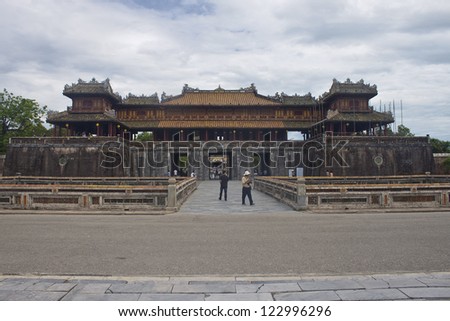 HUE, VIETNAM - JULY 31: Tourists in font of a main gate of Citadel on July 31, 2012 in Hue, Vietnam. Citadel in Hue is enlisted in UNESCO World Heritage Sites.