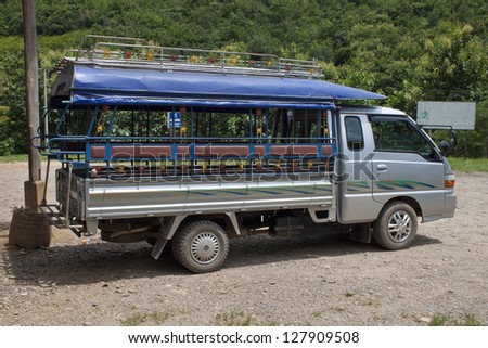 MUANG KHUA, LAOS - AUGUST 14: Local mean of transport (passenger truck) on August 14, 2012 in Muang Khua, Laos. This is a very typical mean of transport in Laos.