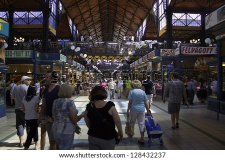 BUDAPEST - AUGUST 10: Tourists and local customers in the Great Market Hall on August 10, 2012 in Budapest, Hungary. The city\'s largest covered market hall opened in 1897.