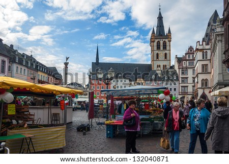 TRIER, GERMANY- SEPTEMBER 29: People and stalls at Market square in Trier, Germany, on September 29, 2012. Trier is the oldest city in Germany, founded in 16 BC.