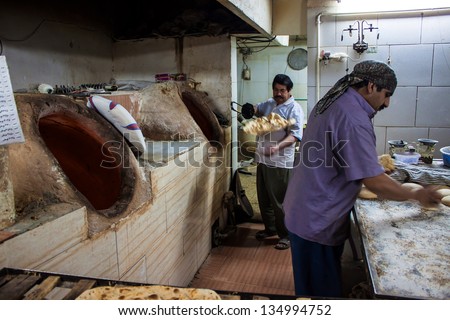 YAZD, IRAN - MARCH 3: Workers in a bakery on March 3, 2013 in Yazd, Iran. Flat bread is the most important staple in Iran.
