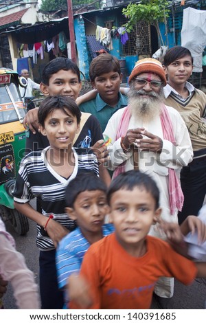 AHMEDABAD, INDIA - SEPTEMBER 7: Unidentified happy children and an old man at September 7, 2011 in Ahmedabad, India. Ahmedabad is the fifth largest city in India, with a population of 5.6 million.