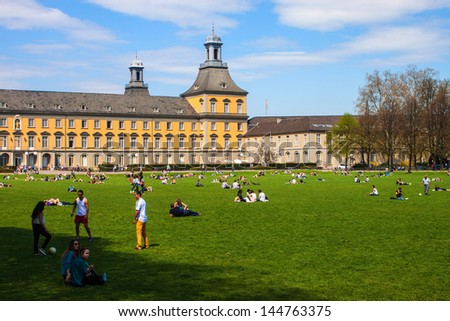 BONN - APRIL 25: People enjoy a sunny day in Hofgarten park in Bonn, Germany on April 25, 2013. Bonn is former capital of Germany with population of 330,000.