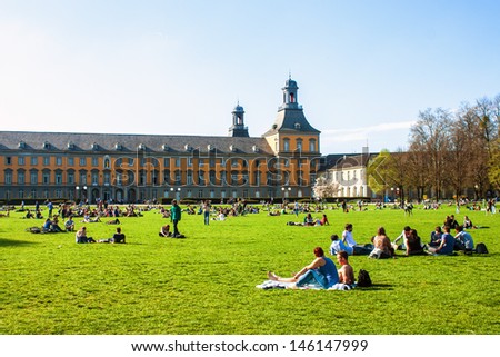 BONN - APRIL 24: People enjoy a sunny day in Hofgarten park in Bonn, Germany on April 24, 2013. Bonn is former capital of Germany with population of 330,000.