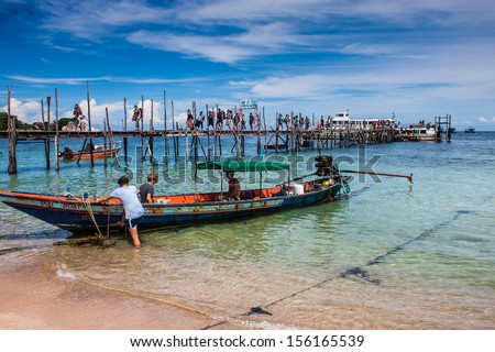 KO TAO, THAILAND - AUGUST 27: People on a pier at Ko Tao, Thailand on August 27, 2013. Ko Tao is small island centered around tourism, especially scuba diving.
