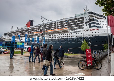HAMBURG, GERMANY - MAY 23: Transatlantic ocean liner RMS Queen Mary 2 in port of Hamburg, Germany on May 23, 2013. Queen Mary 2 is the largest ocean liner ever built.