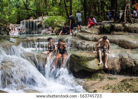 ERAWAN, THAILAND - AUG 25: People bath in Erawan waterfall, Thailand on Aug 25, 2013.Waterfall is named after the Erawan, the three-headed white elephant of Hindu mythology.