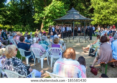 BONN, GERMANY - JULY 7: Jazz choir of University of Bonn sings during a concert in local botanical garden on July 7, 2013 in Bonn, Germany.