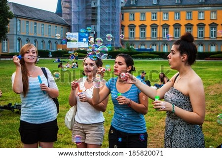 BONN, GERMANY - JULY 22: Students of University in Bonn blow bubbles on July 22, 2013 in Bonn, Germany. University Bonn have 31,000 students.