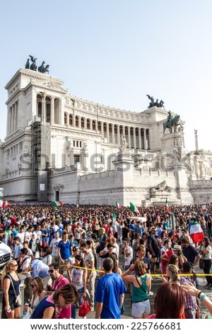 ROME, ITALY - JUNE 24: Crowd of football fans in front of Famous Italian monument Vittorio Emanuele II in Rome, Italy on June 24, 2014. They watch the match Italy-Uruguay of the Wolrd Cup.
