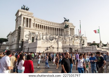 ROME, ITALY - JUNE 24: Crowd of football fans in front of Famous Italian monument Vittorio Emanuele II in Rome, Italy on June 24, 2014. They watch the match Italy-Uruguay of the World Cup.