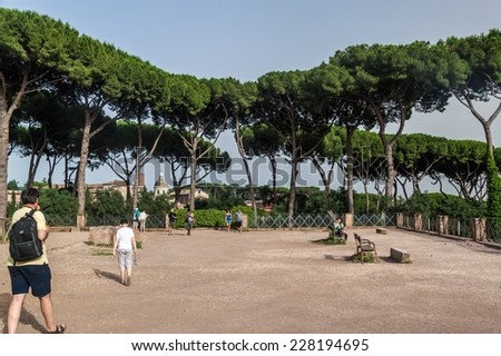ROME - JUNE 24, 2014: Tourists visiting park at the ruins of Rome Forum on June 24, 2014 in Rome. The park is situated at the top of some ancient structures,