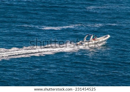 SORRENTO, ITALY - JUNE 29, 2014: Fast boat on turquoise sea in Sorrento. Sorrento is a small town in Campania, southern Italy.
