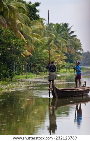 BACKWATERS, INDIA - AUGUST 24: People in a canoe on August 24, 2011 in Backwaters, India. The Kerala Backwaters are a network of interconnected canals, rivers, lakes and inlets.