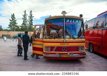 NAEIN, IRAN - MARCH 4: People step into a bus in Naein, Iran on March 4, 2013. Bus transport is very cheap and popular in Iran.