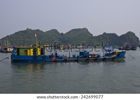 CAT BA, VIETNAM - AUGUST 4: Tanker near port on August 4, 2012 in Cat Ba, Vietnam. Town receives more than 350,000 visitors a year.