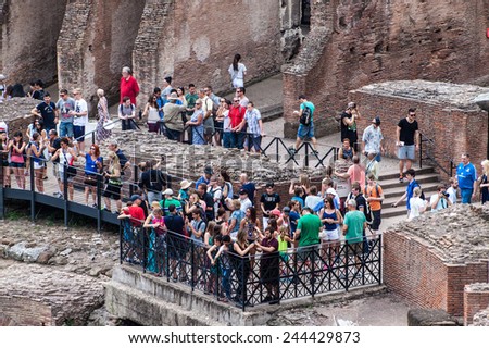 ROME - JUNE 25: Tourists visit Colosseum on June 25, 2014 in Rome, Italy. The Colosseum is one of Rome\'s most popular tourist attractions with over 5 million visitors per year.