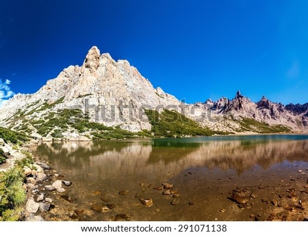 Mountains reflecting in Laguna Toncek lake near Bariloche, Argentina