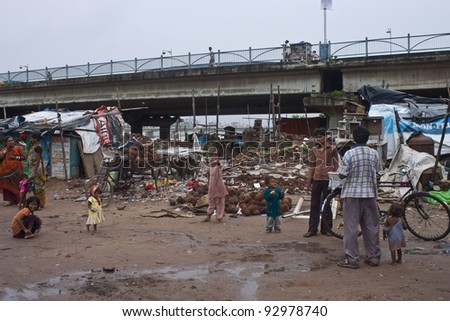 AHMEDABAD, INDIA - SEPTEMBER 7: Unidentified poor people living in slum at September 7, 2011 in Ahmedabad, India. About 40 % of Ahmedabad inhabitants live in slums.