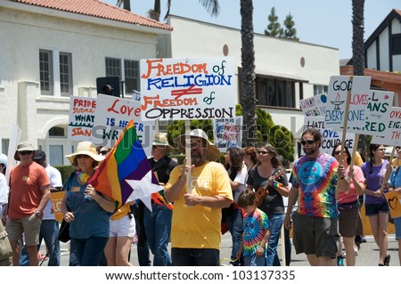 LONG BEACH - MAY 20: People with signs demanding freedom of religion, at the Long Beach Lesbian and Gay Pride Parade 2012 on May 20, 2012 in Long Beach, California.