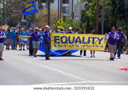 LONG BEACH - MAY 20: Activists holding a Human Rights campaign banner promoting Equality during the Long Beach Lesbian and Gay Pride Parade 2012 on May 20, 2012 in Long Beach, California.
