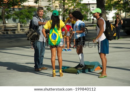 RIO DE JANEIRO, BRAZIL - JUNE 11: Brazilian soccer fan posing next to a man dressed like Diego Maradona outside the Maracana stadium, one day before the FIFA World Cup started, on June 11, 2014.