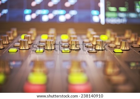 Close-up of audio mixing controller console