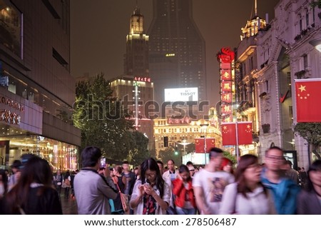 SHANGHAI, CHINA - MAY 2, 2015: Visitors at Nanjing Road. It is the main shopping street of Shanghai, China, and is one of the world\'s busiest shopping streets.