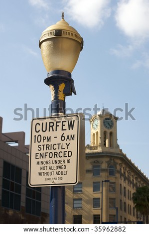 Curfew sign in Downtown Long Beach, California. Minors under 18 not allowed without an adult
