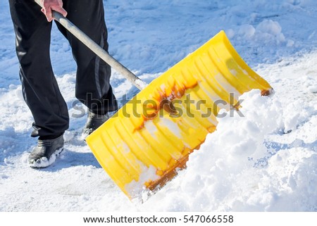 shoveling snow shovel in hand