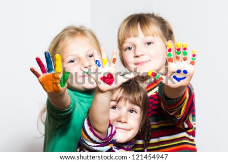 Happy little girls with painted hands