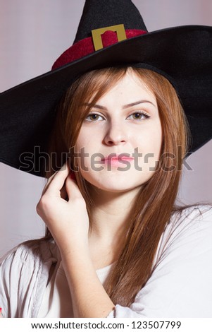 Young beautiful girl with witch hat