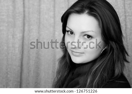 Portrait of a beautiful teen girl with long curly hairs-black and white