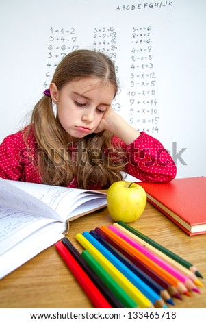 Little schoolgirl solving mathematics problem