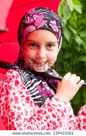 Little muslim girl with umbrela