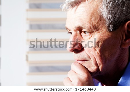 close-up portrait of a senior man thinking