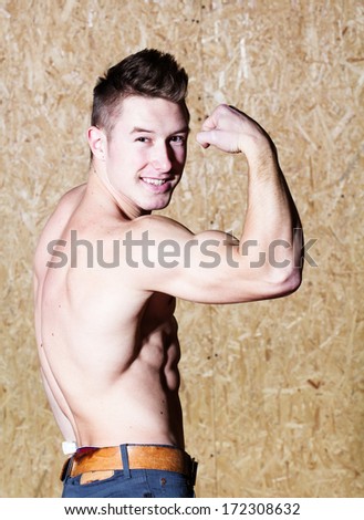Young muscle man posing