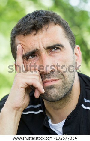 Young worried man smoking a cigarette and thinking about the problem