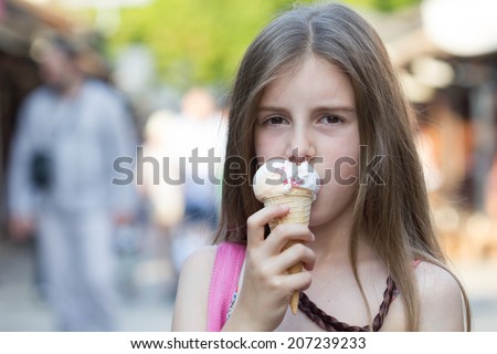 Happy little child eating ice-cream