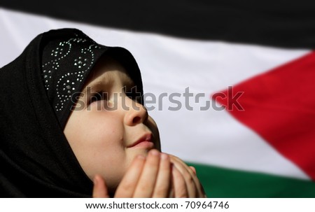 Little Palestine girl praying - Palestine flag in background