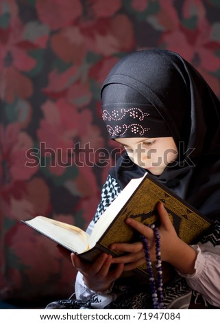 Muslim girl reading Koran