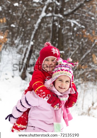 two little girls playing on the snow